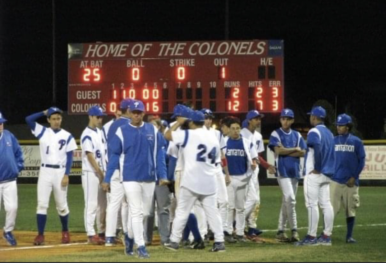 Plantation High School coaching staff and team on the field