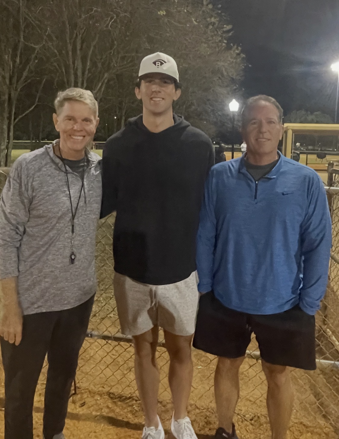 Joel Bradley photographed with Andy Painter and Peter Painter at a ballfield