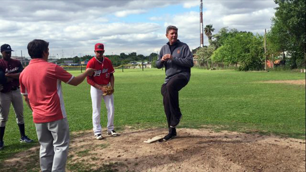 On the mound in Jupiter — teaching delivery mechanics to a young international arm.
