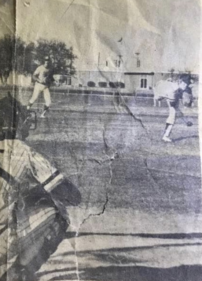 Newspaper photograph of Joel D. Bradley pitching in high school
