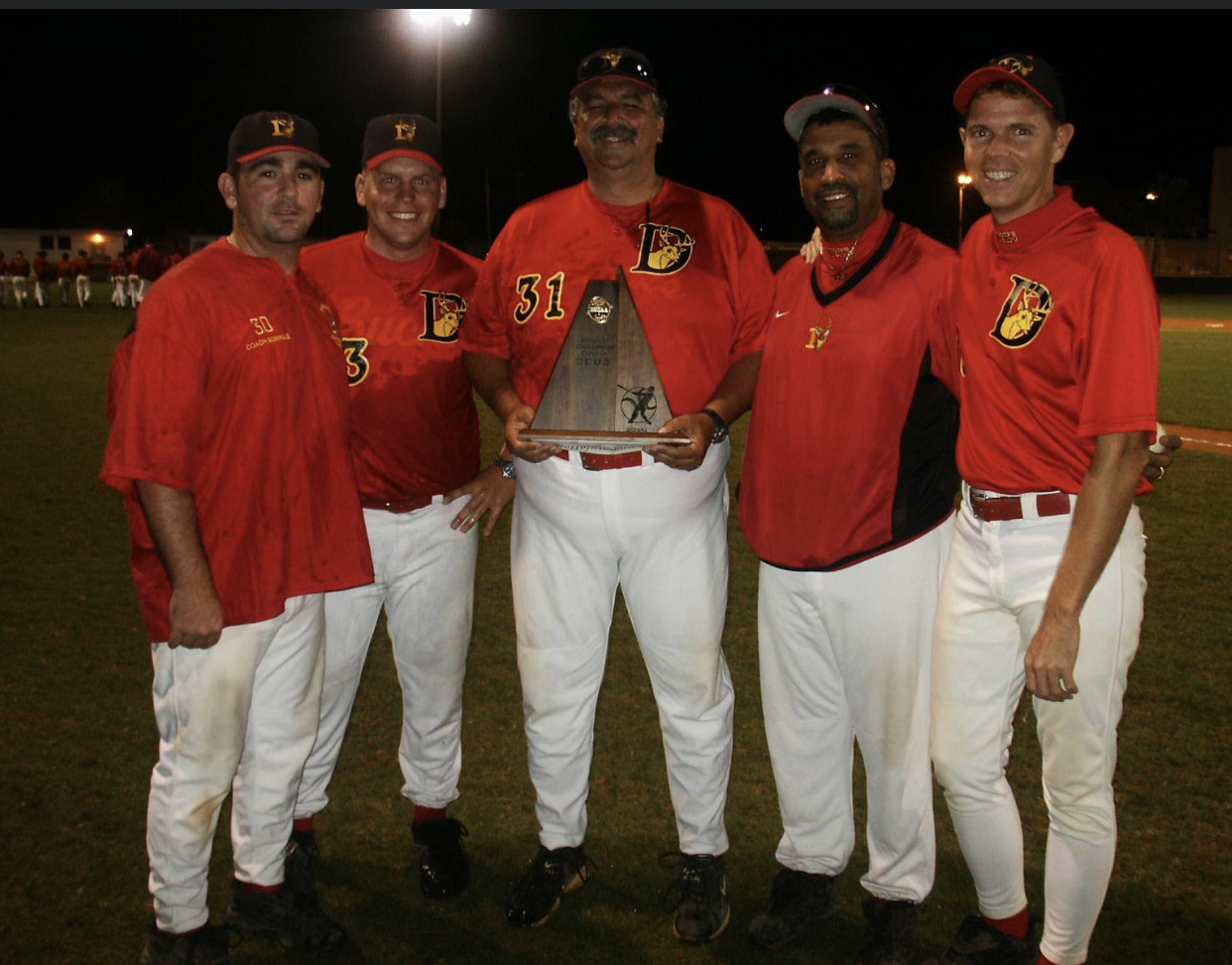 Deerfield Beach High School coaching staff with the 2003 district championship trophy